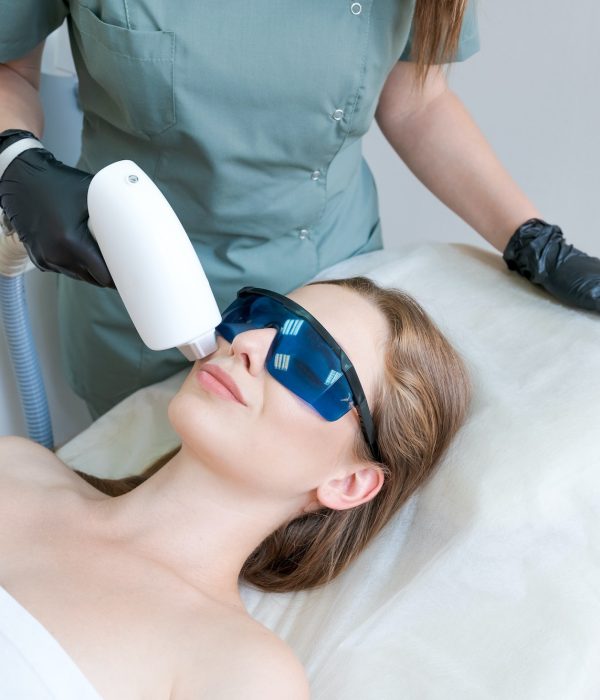 therapist-cosmetologist-undergoes-laser-treatment-on-face-young-woman-in-beauty.jpg